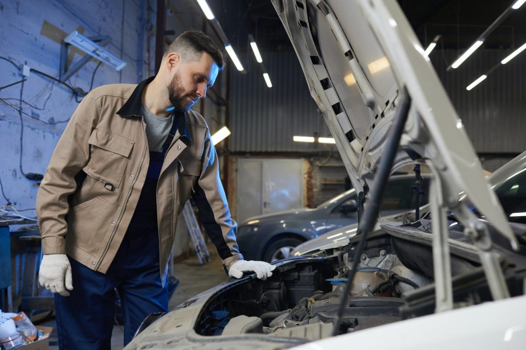 Repairman Looking At Car Engine