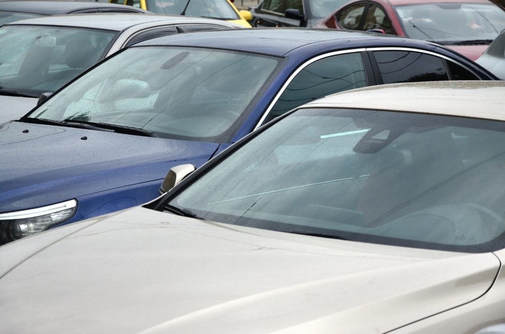 Roofs of several cars. A lot of cars stand close at rush hour